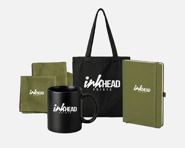 Promotional products including a black mug, green notebook, black tote bag, and green pouches with 'inkHEAD' branding on a white background.