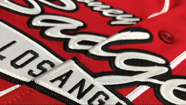 Close-up of a red jacket with 'Powell Peralta' branding and text.